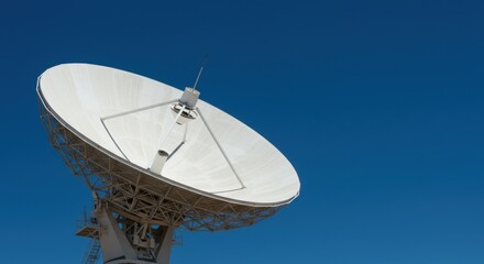 Large Satellite Dish Antenna Pointing Towards a Clear Blue Sky.