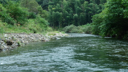 The mountains and valley view with the river running through them in summer
