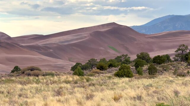 The Great Sand Dunes National Park Sangre de Cristo range Rocky Mountains spring summer raining sunny cloudy Colorado unique magical large amounts of sand dune hills windy landscape Crestone Needle