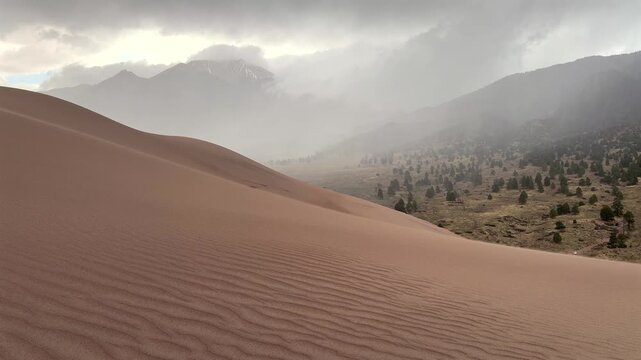 High Winds Great Sand Dunes National Park Spring summer stormy foggy cloudy raining mist Crestone Needle peak Colorado Sangre de Cristo range Rocky Mountains magical large amounts of sand dune hills