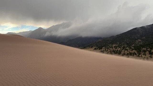 Windy Great Sand Dunes National Park Spring summer stormy foggy cloudy raining mist Crestone Needle peak Colorado Sangre de Cristo range Rocky Mountains magical large amounts of sand dune hills static