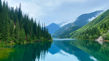 The first Kolsai Lake is a picturesque place in the mountains of Kazakhstan. Beautiful mountain lake with forest and green hills. The pearl of the Tien Shan