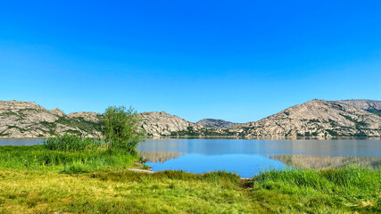 Rest at Lake Shalkar in western Kazakhstan. A beautiful lake belonging to the group of Five Kokshetau lakes. The reservoir is surrounded by rocky mountains