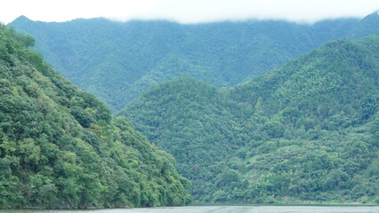 The mountains and valley view with the river running through them in summer
