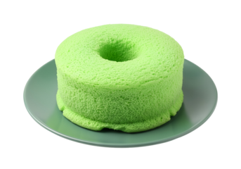 A vibrant lime-green sponge cake, presented on a muted gray plate, sits against a black background.