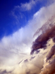 Thick stormy thunderstorm clouds in a blue sky