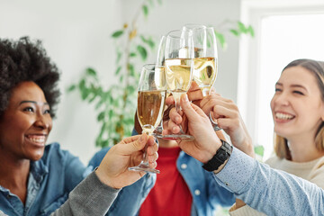 A portrait of young businesspeople or friends celebrating business success with a tost  in the office or young people having a party, teamwork and togetherness and having fun and friendship concept