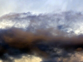 Thick stormy thunderstorm clouds in a blue sky