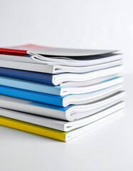 Stack of colorful books on white surface