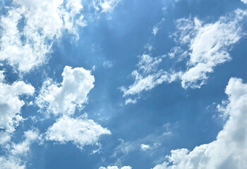 Blue Sky with White Fluffy Clouds. Natural Background for Weather, Nature, and Travel Concepts....