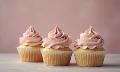 homemade cupcakes with paper toppers and cream frosting