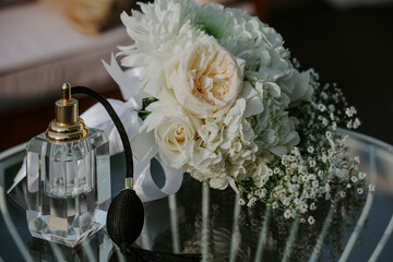  Romantic bridal bouquet with perfume bottle and wedding jewelry.