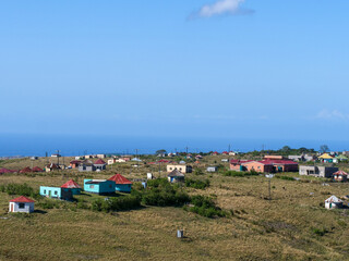 Houses of communities in rural Transkei, South Africa, on hills, surrounded by yellow grasslands which is used for grazing by cattle