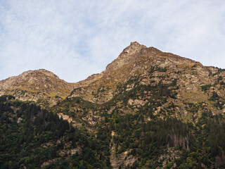 Majestic mountain peak with rugged terrain under cloudy sky