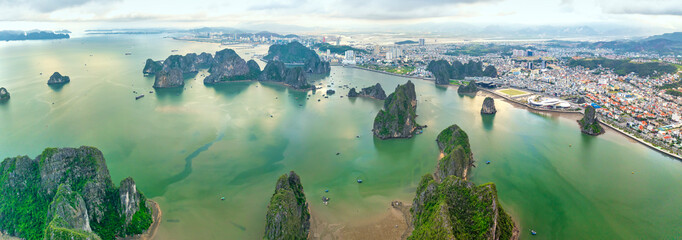 Aerial view floating fishing village and rock island, Halong Bay, Vietnam, Southeast Asia. UNESCO World Heritage Site. Junk boat cruise to Ha Long Bay. Popular landmark, famous destination of Vietnam © huythoai