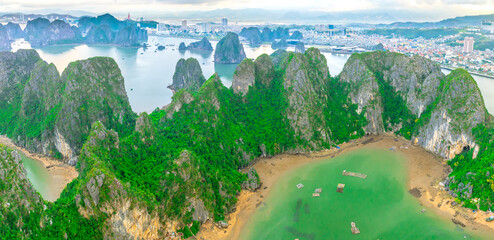 Aerial view floating fishing village and rock island, Halong Bay, Vietnam, Southeast Asia. UNESCO World Heritage Site. Junk boat cruise to Ha Long Bay. Popular landmark, famous destination of Vietnam © huythoai
