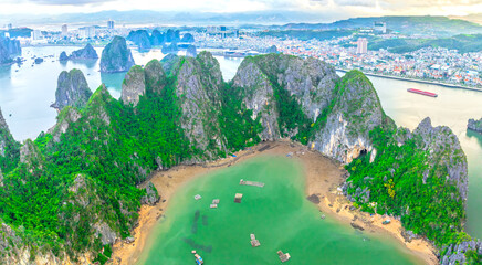 Aerial view floating fishing village and rock island, Halong Bay, Vietnam, Southeast Asia. UNESCO World Heritage Site. Junk boat cruise to Ha Long Bay. Popular landmark, famous destination of Vietnam © huythoai