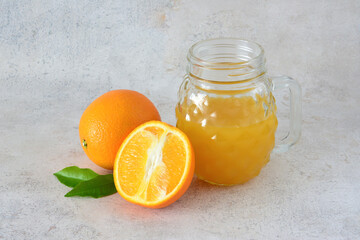Fresh Orange Juice with Whole and Halved Oranges