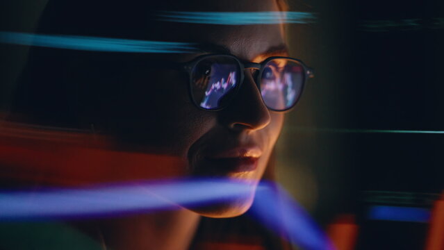 Night woman charts reflection wearing eyeglasses looking computer screen closeup