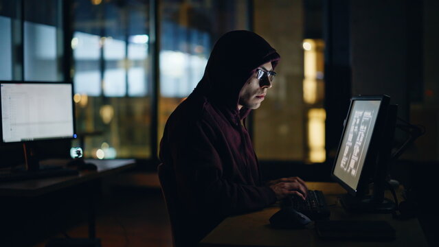 Hacker writing data computer keyboard in night high-tech room alone closeup - Powered by Adobe