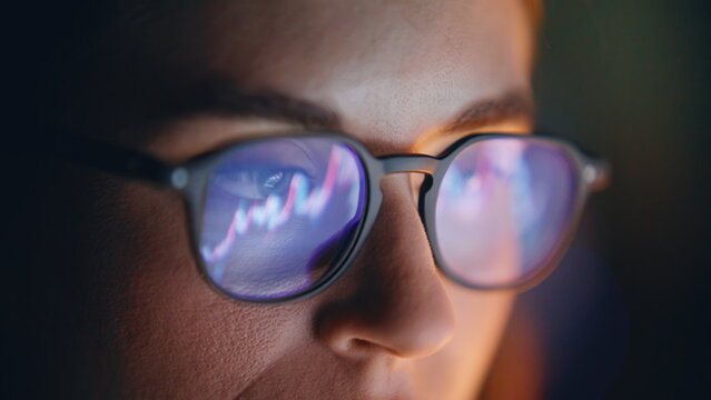 Diagrams woman glasses reflection closeup. Market trader face looking charts