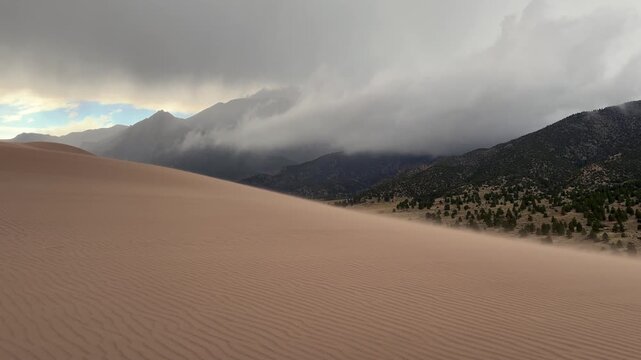 Windy Great Sand Dunes National Park Spring summer stormy foggy cloudy raining mist Crestone Needle peak Colorado Sangre de Cristo range Rocky Mountains magical large amounts of sand dune hills zoom
