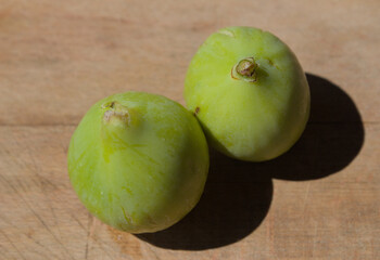Green figs on a wooden cutting board