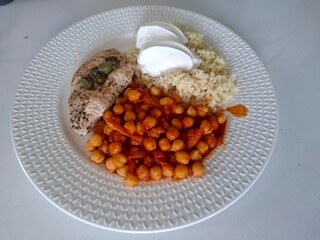 Healthy lunch meal. Chickpea. Chicken fillet, bulgur and yogurt on the plate.