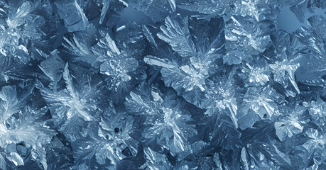 Macro frosty patterns of intricate ice crystals on a cold surface, blue winter background