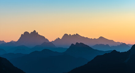 Layered Mountain Silhouettes at Sunset Gradient Sky Landscape
