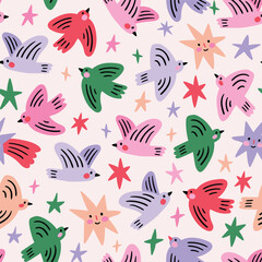Fototapeta premium Vector bright Christmas bird seamless pattern. Winter holiday print design with colorful birds and stars ob beige background. New year pattern for fabric or wrapping paper.