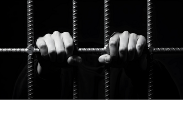 A monochrome depiction of despair as anonymous hands clutch cold steel prison bars, symbolizing a profound loss of freedom and hope