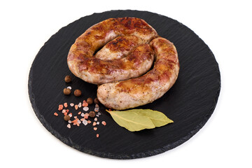 Grilled Sausage on Black Stone Plate, isolated on white background