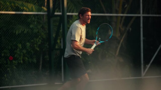 Man playing intense tennis game, demonstrating active and dynamic sports fitness