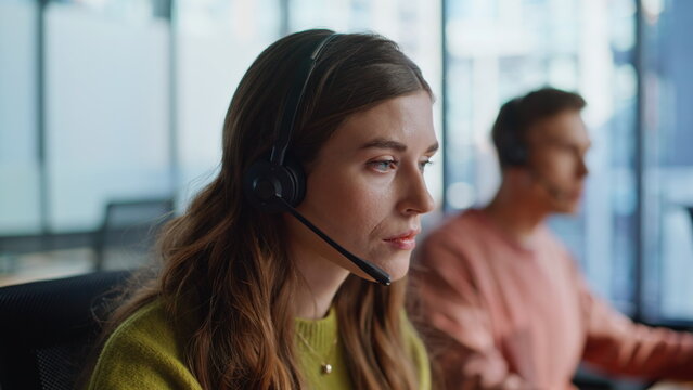 Thoughtful support agent listening customer solving request at workplace closeup