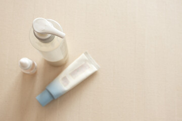 Skincare and cosmetic products on neutral beige background. Beauty, dermatology, personal care, wellness, and natural cosmetic branding concept