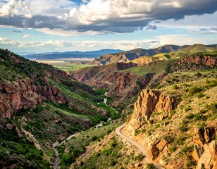 Obraz premium Mountain valley road winding through colorful terrain