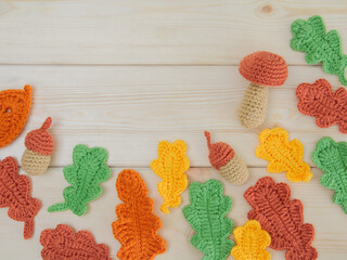 A composition of autumn leaves, mushrooms, acorns, crocheted. Comfort in the house, autumn hobbies...