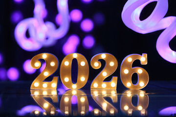 Illuminated marquee numbers 2026 with bokeh lights background
