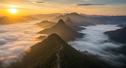 Sunrise over mountain peaks through cloudscape