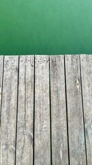 Wooden pier above green water