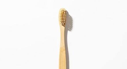 Natural Bamboo Toothbrush with Yellow Bristles on White Background.