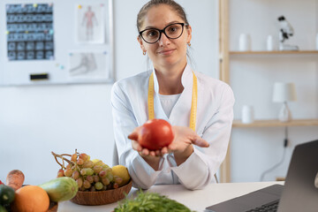 Healthy food, right nutrition and diet. Young caucasian nutritionist giving consultation to patient...