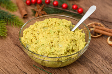 Salad bowl with herring salad, sour cream, curry spices and grated apples, sweet and salty