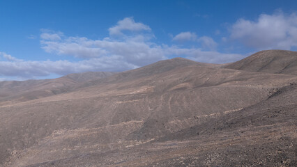 Desert Track Through Volcanic Hills Under Clear Sky – Remote Arid Landscape