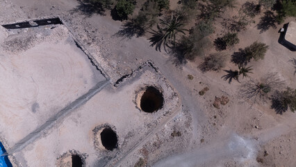 Ancient Water Wells and Ruins in Desert Landscape &ndash; Aerial View of Historical Site
