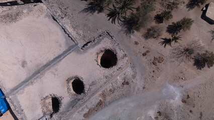 Ancient Water Wells and Ruins in Desert Landscape &ndash; Aerial View of Historical Site