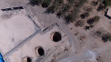 Ancient Water Wells and Ruins in Desert Landscape &ndash; Aerial View of Historical Site