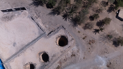 Ancient Water Wells and Ruins in Desert Landscape &ndash; Aerial View of Historical Site
