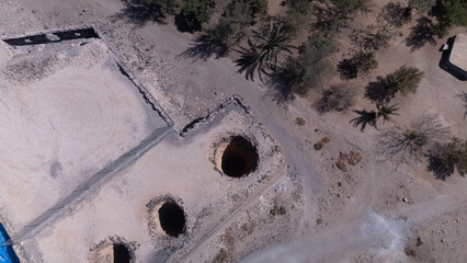 Ancient Water Wells and Ruins in Desert Landscape &ndash; Aerial View of Historical Site